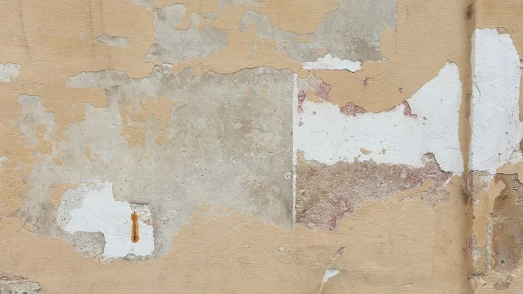 Pressing spackle into a wall hole
